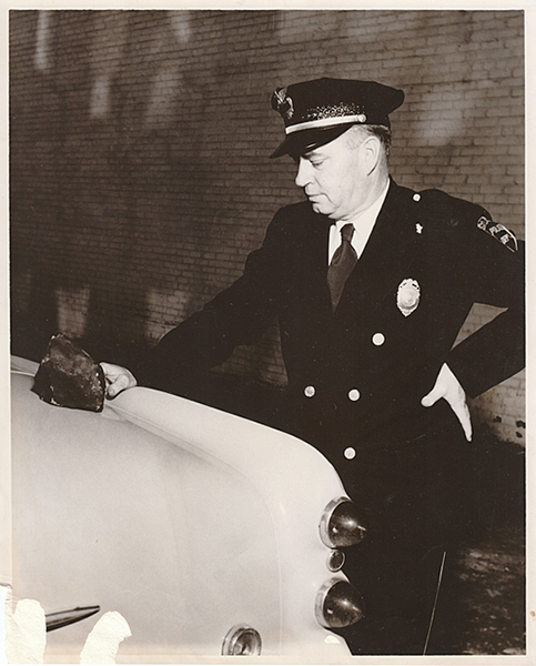 Police chief with meteorite, photographed by Harmon Mims, 1954
